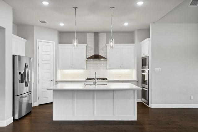 13313 Rembrandt Dr, Frisco, TX 75035 - kitchen featuring appliances with stainless steel finishes, wall chimney range hood, light countertops, dark wood-type flooring, and recessed lighting