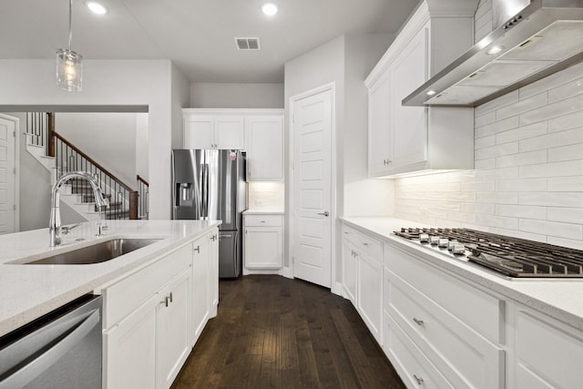 13313 Rembrandt Dr, Frisco, TX 75035 - kitchen with range hood, appliances with stainless steel finishes, dark wood finished floors, recessed lighting, and white cabinets