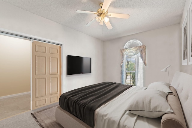 808 Elbe Dr, Arlington, TX 76001 - carpeted bedroom featuring a textured ceiling and a ceiling fan