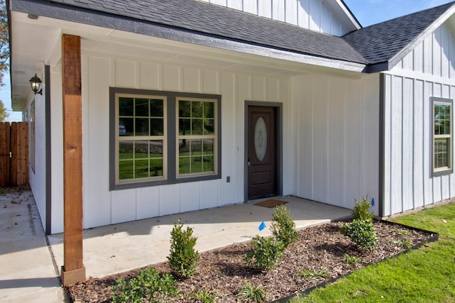 205 John Fielder, Sherman, TX 75092 - view of exterior entry featuring roof with shingles, board and batten siding, and a porch