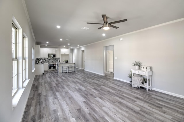205 John Fielder, Sherman, TX 75092 - unfurnished living room featuring crown molding, ceiling fan, recessed lighting, and wood finished floors