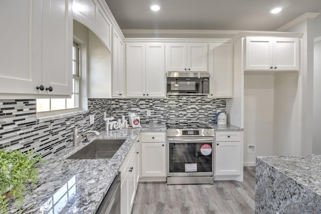 205 John Fielder, Sherman, TX 75092 - kitchen featuring stainless steel appliances, white cabinetry, backsplash, crown molding, and light wood finished floors