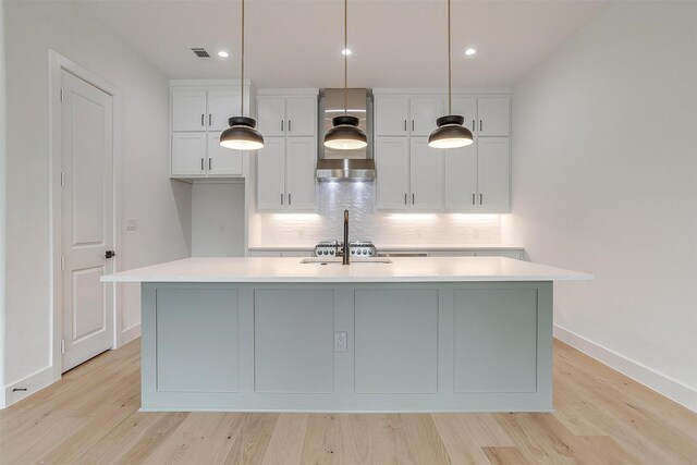 123 Thornton St, Arlington, TX 76013 - kitchen featuring white cabinets, light countertops, a kitchen island with sink, backsplash, and recessed lighting