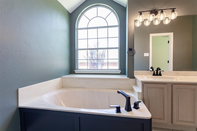 1526 Shadow Run, Weatherford, TX 76086 - full bath featuring plenty of natural light, a textured wall, vanity, a bath, and vaulted ceiling