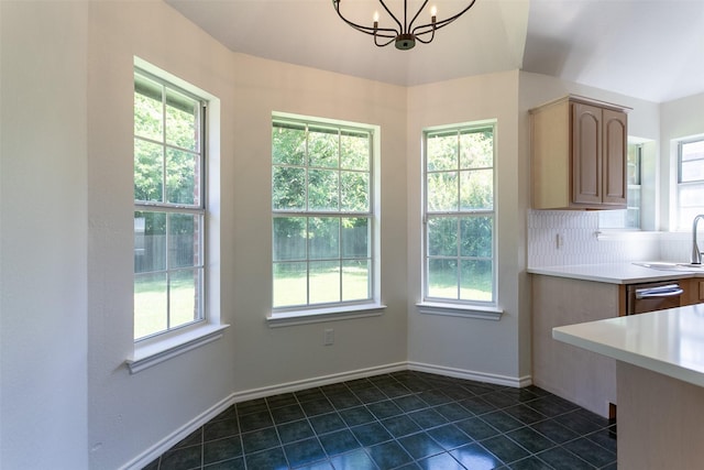 1526 Shadow Run, Weatherford, TX 76086 - unfurnished dining area with healthy amount of natural light, a chandelier, and dark tile patterned flooring