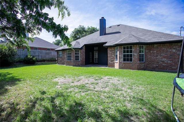 1526 Shadow Run, Weatherford, TX 76086 - back of property with a chimney, brick siding, and a shingled roof