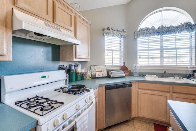 5615 Wellston Dr, Arlington, TX 76018 - kitchen with white range with gas cooktop, stainless steel dishwasher, under cabinet range hood, light tile patterned flooring, and light countertops