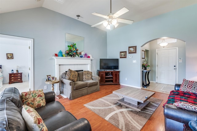 5615 Wellston Dr, Arlington, TX 76018 - living area with arched walkways, ceiling fan, vaulted ceiling, and light wood-style flooring