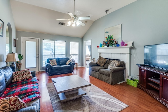 5615 Wellston Dr, Arlington, TX 76018 - living area featuring a ceiling fan, wood finished floors, arched walkways, a fireplace, and high vaulted ceiling