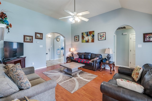5615 Wellston Dr, Arlington, TX 76018 - living area with arched walkways, vaulted ceiling, a ceiling fan, and light wood-style floors