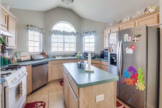 5615 Wellston Dr, Arlington, TX 76018 - kitchen with appliances with stainless steel finishes, light brown cabinetry, vaulted ceiling, a kitchen island, and light tile patterned floors