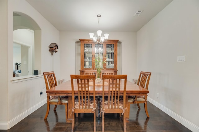 6159 Allatoona Rd, Fort Worth, TX 76179 - dining area with arched walkways, a chandelier, and dark wood-type flooring