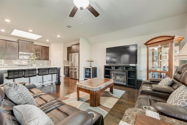 6159 Allatoona Rd, Fort Worth, TX 76179 - living room featuring dark wood-style flooring, beverage cooler, recessed lighting, a skylight, and a ceiling fan