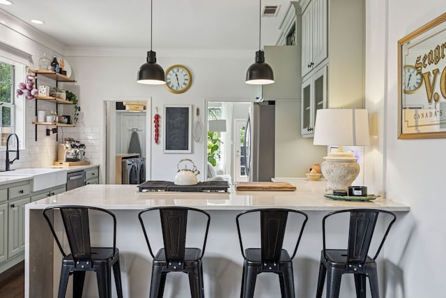 522 S Winnetka Ave, Dallas, TX 75208 - kitchen with a kitchen breakfast bar, tasteful backsplash, ornamental molding, a peninsula, and decorative light fixtures