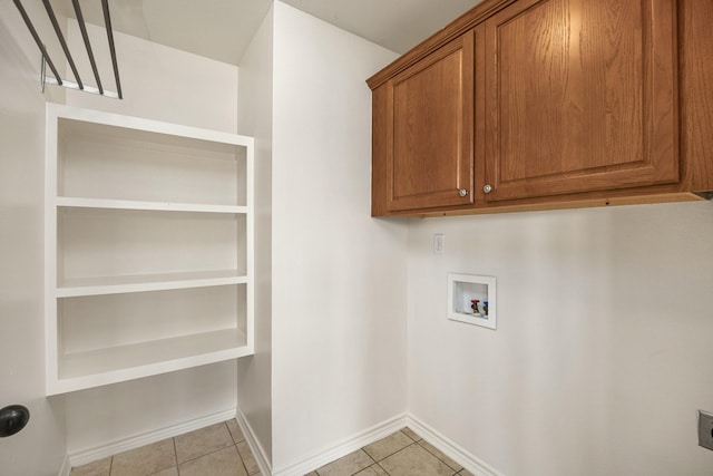 6630 Lacebark Cir, Tyler, TX 75703 - laundry room with cabinet space, light tile patterned flooring, and washer hookup