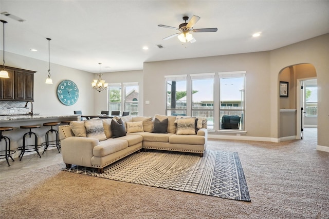 5009 Thistle Hl, Denton, TX 76210 - living area with arched walkways, plenty of natural light, ceiling fan, recessed lighting, and a chandelier