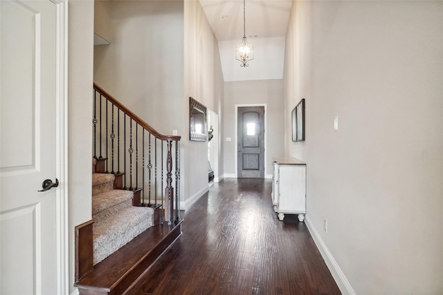 5009 Thistle Hl, Denton, TX 76210 - foyer featuring dark wood-style flooring, a chandelier, stairs, and a high ceiling