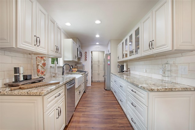 1202 Carroll Dr, Garland, TX 75041 - kitchen featuring appliances with stainless steel finishes, decorative backsplash, wood finished floors, glass insert cabinets, and recessed lighting
