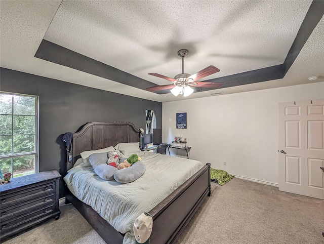114 Bluebird Ln, Whitehouse, TX 75791 - bedroom with carpet flooring, a tray ceiling, a textured ceiling, and a ceiling fan