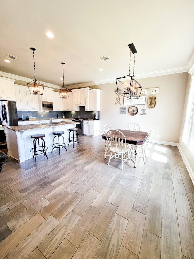 104 St Andrews Ln, Benton, LA 71006 - dining space with a chandelier, ornamental molding, light wood-type flooring, and recessed lighting