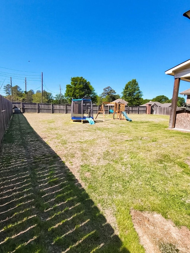 104 St Andrews Ln, Benton, LA 71006 - fenced backyard with a trampoline and a playground