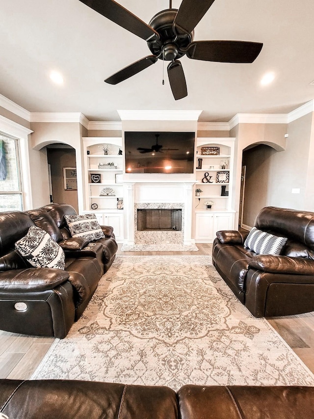 104 St Andrews Ln, Benton, LA 71006 - living room with arched walkways, wood finished floors, a ceiling fan, and ornamental molding