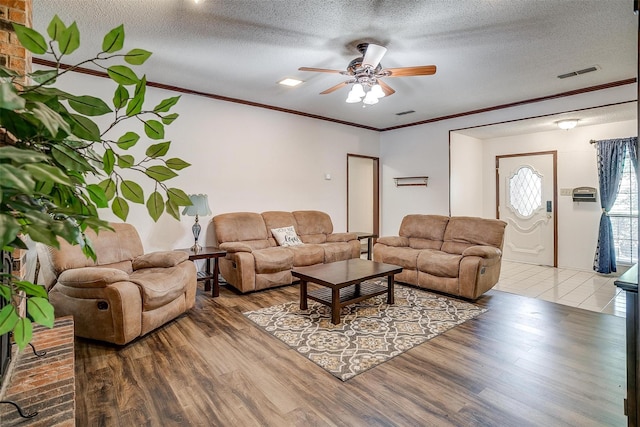 6824 Ridgewood Dr, North Richland Hills, TX 76182 - living area with a ceiling fan, wood finished floors, a textured ceiling, and ornamental molding