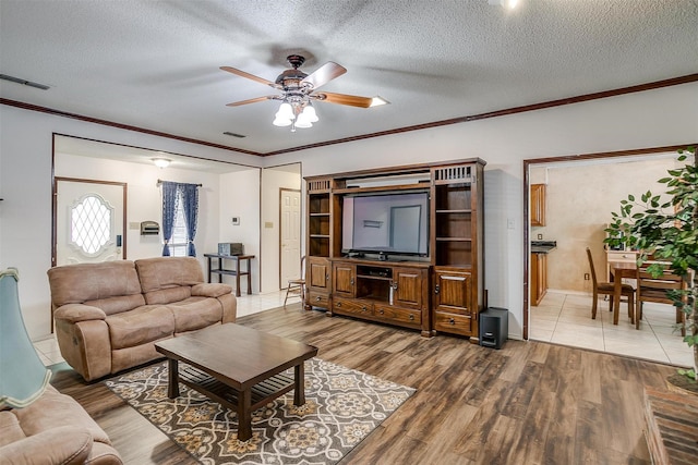 6824 Ridgewood Dr, North Richland Hills, TX 76182 - living area featuring ceiling fan, crown molding, wood finished floors, and a textured ceiling