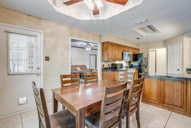 6824 Ridgewood Dr, North Richland Hills, TX 76182 - dining space featuring ceiling fan, light tile patterned flooring, and a textured ceiling