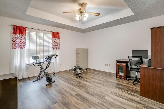 6824 Ridgewood Dr, North Richland Hills, TX 76182 - exercise area with a tray ceiling, wood finished floors, and a ceiling fan