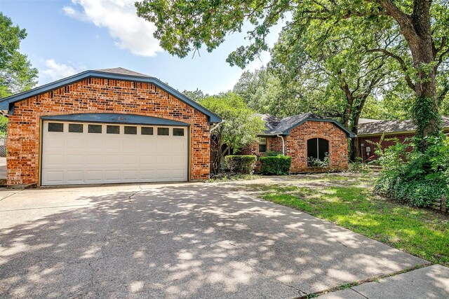 6824 Ridgewood Dr, North Richland Hills, TX 76182 - view of front of property featuring brick siding, concrete driveway, and an attached garage