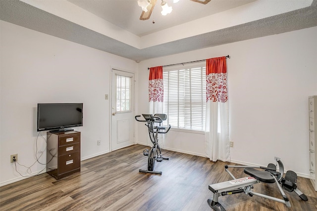 6824 Ridgewood Dr, North Richland Hills, TX 76182 - workout area with wood finished floors, ceiling fan, plenty of natural light, and a tray ceiling