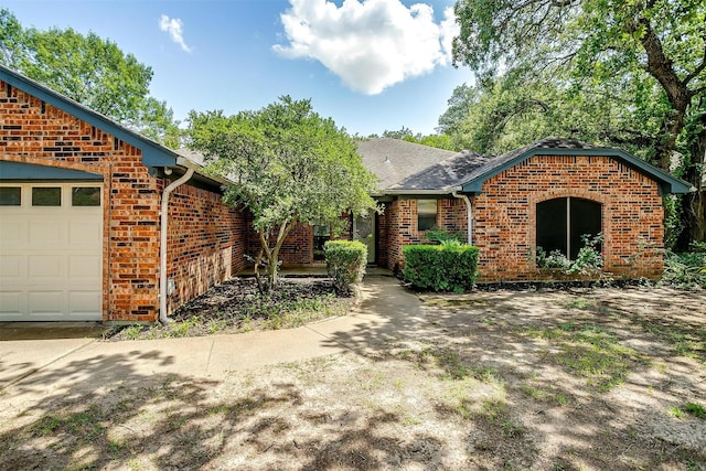 6824 Ridgewood Dr, North Richland Hills, TX 76182 - view of front of home featuring brick siding, an attached garage, and roof with shingles