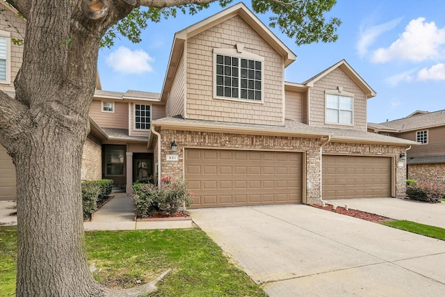 921 Englewood Ln, Plano, TX 75025 - view of property featuring concrete driveway, an attached garage, and brick siding