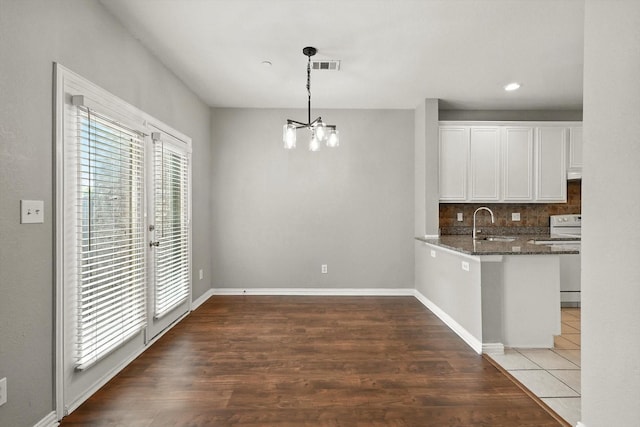 921 Englewood Ln, Plano, TX 75025 - unfurnished dining area with a chandelier, wood finished floors, and recessed lighting