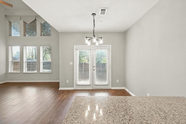 921 Englewood Ln, Plano, TX 75025 - unfurnished dining area with a chandelier, dark wood-style flooring, and french doors