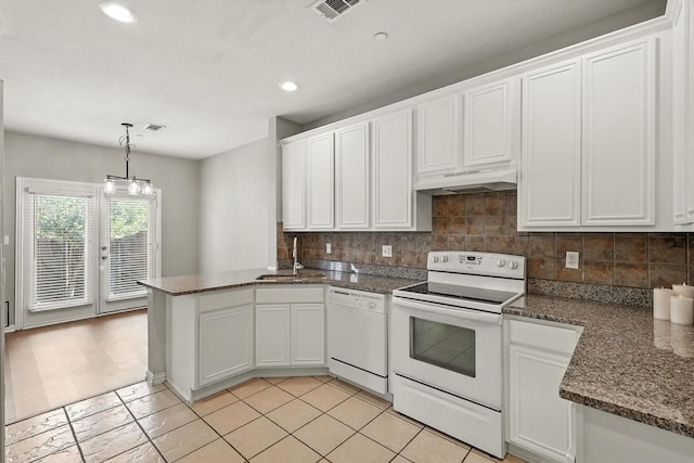 921 Englewood Ln, Plano, TX 75025 - kitchen with white appliances, under cabinet range hood, a peninsula, white cabinetry, and tasteful backsplash