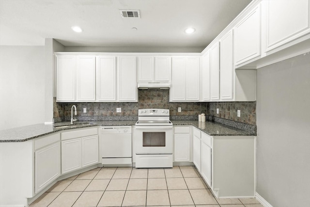 921 Englewood Ln, Plano, TX 75025 - kitchen with white appliances, under cabinet range hood, tasteful backsplash, a peninsula, and white cabinets