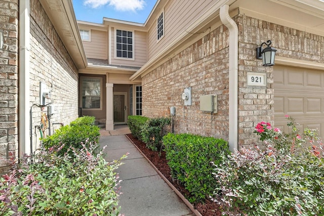 921 Englewood Ln, Plano, TX 75025 - view of exterior entry with an attached garage and brick siding