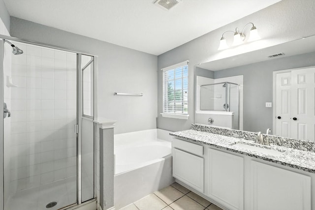 921 Englewood Ln, Plano, TX 75025 - bathroom with vanity, a shower stall, a garden tub, and tile patterned flooring