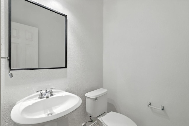 921 Englewood Ln, Plano, TX 75025 - half bathroom with a sink and a textured wall