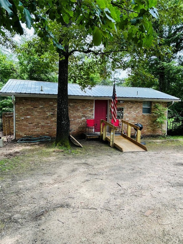 267 Washington, Avinger, TX 75630 - back of house with brick siding and a metal roof