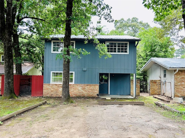 267 Washington, Avinger, TX 75630 - view of front of home with brick siding and a metal roof