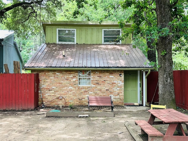 267 Washington, Avinger, TX 75630 - back of property with brick siding, a patio area, and a metal roof