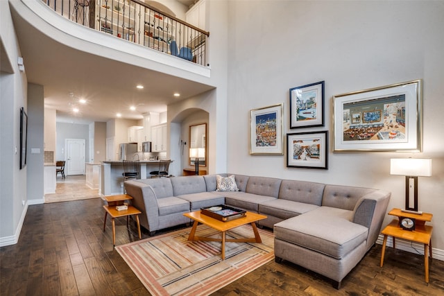 655 Emily Ln, Richardson, TX 75081 - living room featuring dark wood-style flooring, recessed lighting, and arched walkways