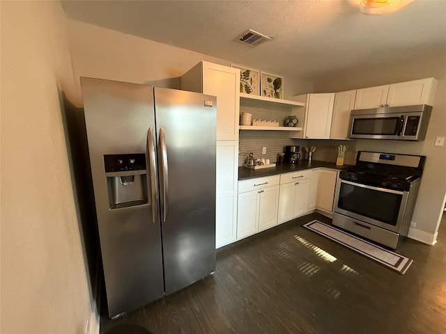 317 W Monterey St, Denison, TX 75020 - kitchen with appliances with stainless steel finishes, dark wood-type flooring, dark countertops, open shelves, and tasteful backsplash