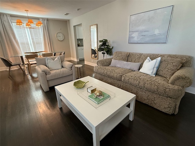 317 W Monterey St, Denison, TX 75020 - living area featuring plenty of natural light and dark wood-style flooring