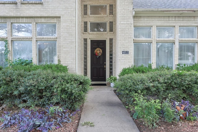 4653 Portrait Ln, Plano, TX 75024 - property entrance featuring brick siding and roof with shingles