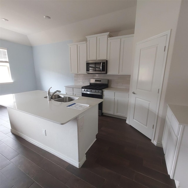 11305 Autry Ridge Ln, Aubrey, TX 76227 - kitchen with stainless steel appliances, dark wood-style flooring, an island with sink, tasteful backsplash, and white cabinetry