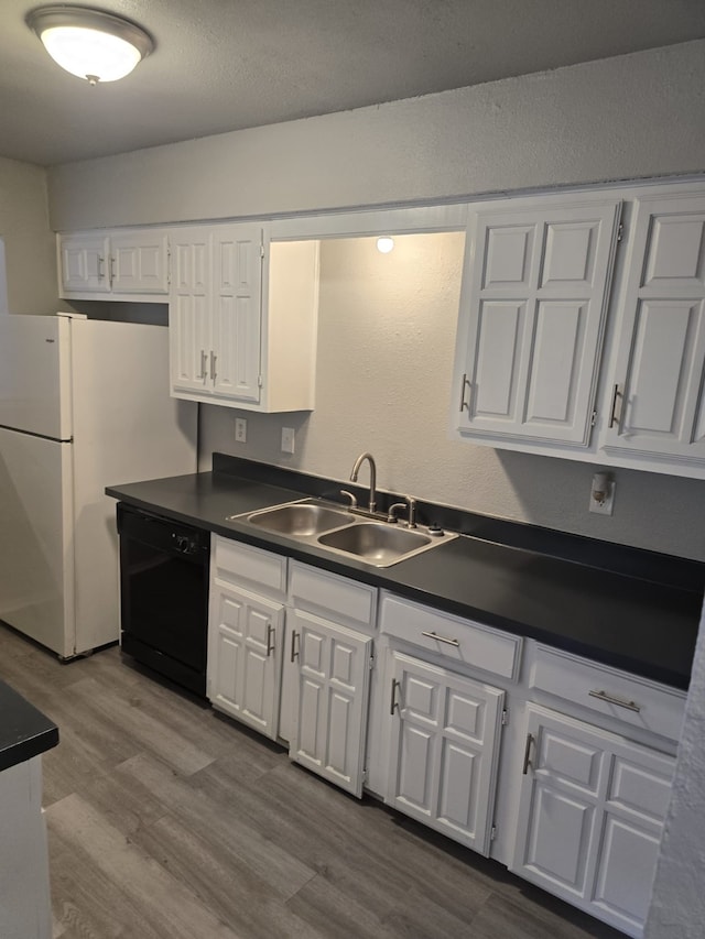 8916 Greenmound Ave, Dallas, TX 75227 - kitchen featuring black dishwasher, dark countertops, white cabinetry, and dark wood-type flooring